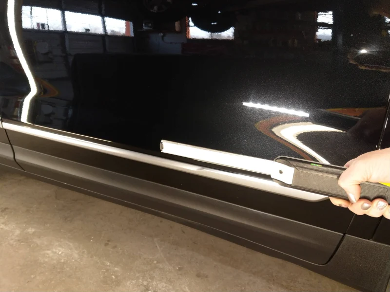 Passenger front door of Cadillac after paint correction showing no swirl marks