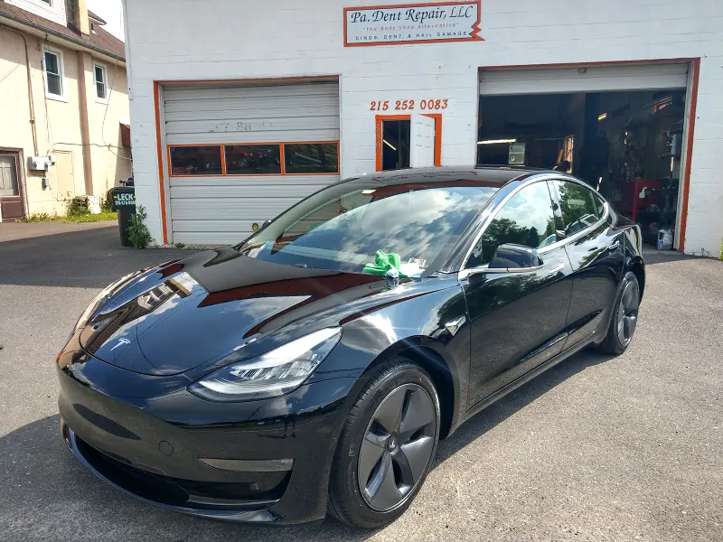 Black Tesla angled left — ceramic coating showcase