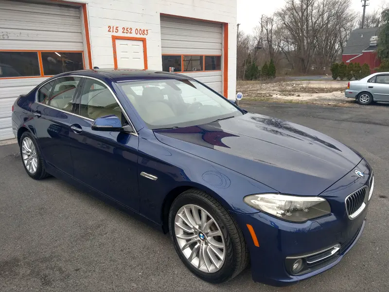 Dark blue BMW sedan angled left — ceramic coating showcase
