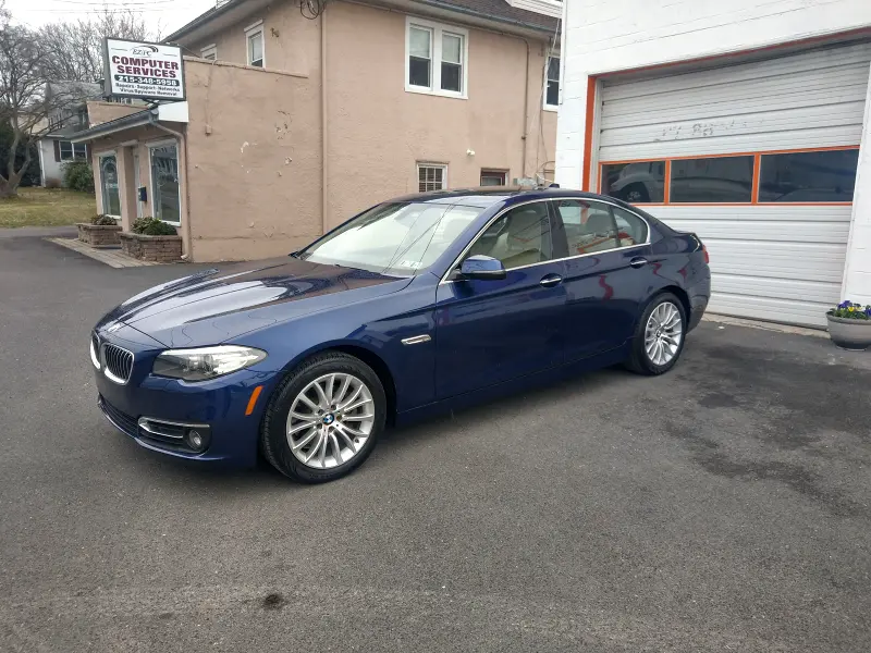 Dark blue BMW sedan angled right — ceramic coating car results