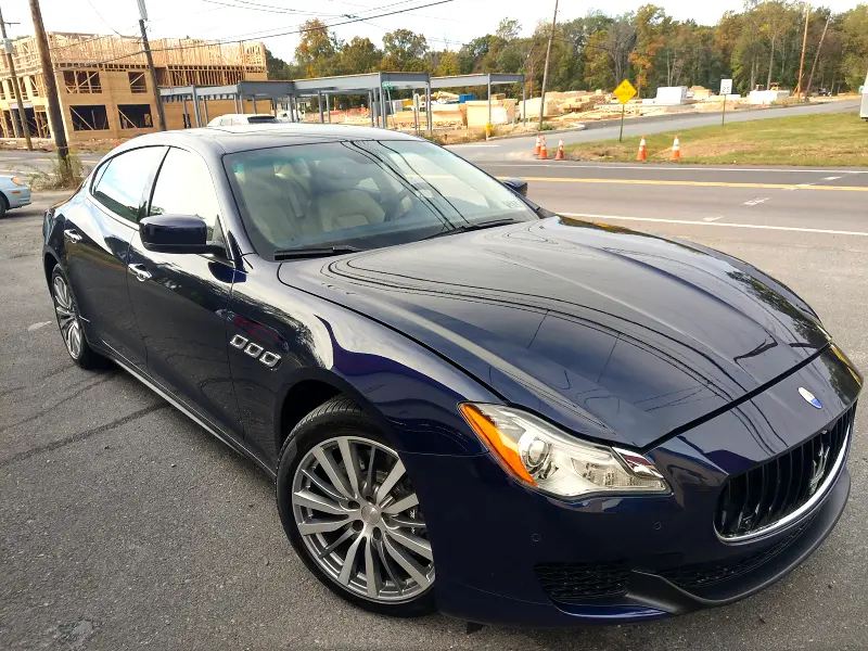 Dark blue Maserati sedan angled left — ceramic coating showcase