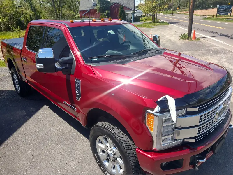 Red Ford truck angled left — finished ceramic coating trucks