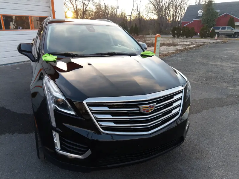 Corrected Cadillac SUV outside facing right, swirl marks removed