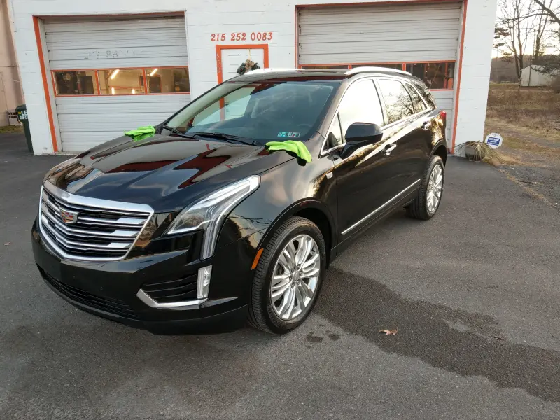 Corrected Cadillac SUV outside, facing left, swirl marks removed.