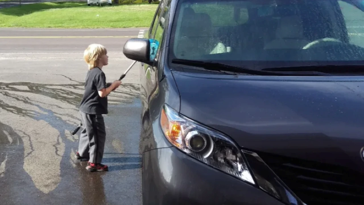 Auto detailer near me washing a grey Toyota Sienna — find a car detailer near me