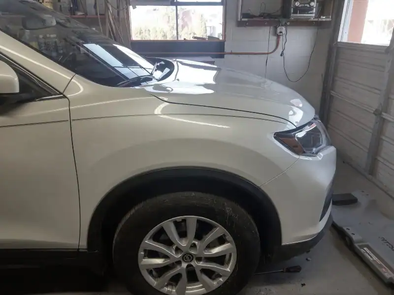 After‑repair photo showing a fender dent restored with paintless dent repair.