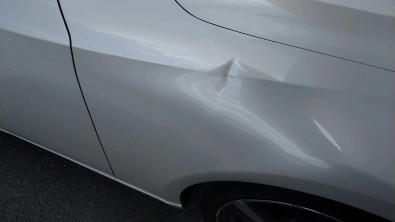 Before‑repair image of a Lexus fender kink documented for a paintless dent repair spotlight case study.