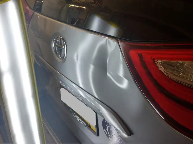 Tailgate dent on a Toyota Sienna suitable for paintless dent repair.