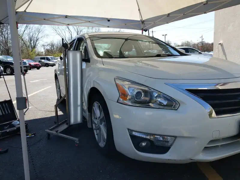 Mobile paintless dent repair setup in a Warminster PA parking lot providing on‑site service.